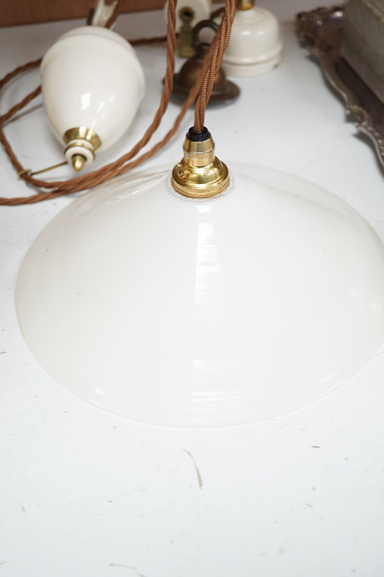 A French ceramic rise and fall ceiling light with opaline coolie shade, circa 1930’s-40’s, wired, overall 68cm high. Condition - good